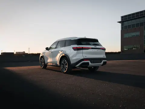 White SUV in a lot at sunset